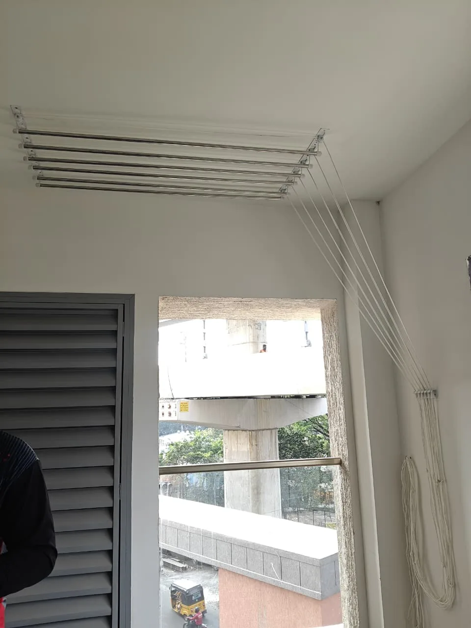Two sets of ceiling cloth hangers fitted in an apartment utility balcony